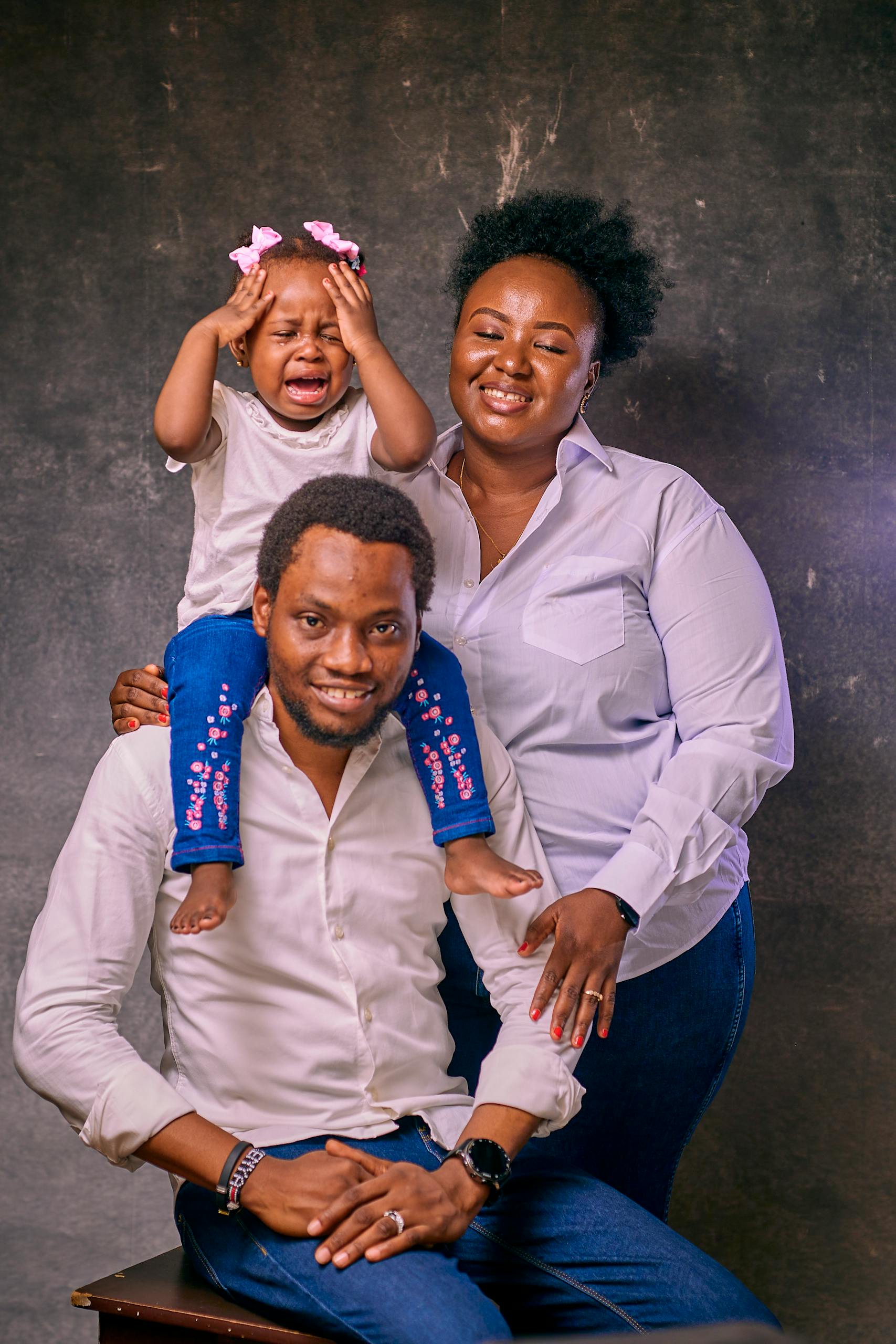 A joyful family portrait featuring parents with their young daughter. with Marketplace Coverage